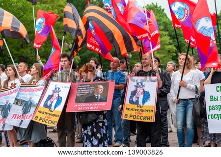 MOSCOW, RUSSIA - 18 MAY 2013: Pro-Putin meeting \'Mass Media - Stop Lying!\' in Moscow, Russia. Placard with Uncle Sam reads \'We control mass media in Russia from 1991\' Moscow 18 May 2013