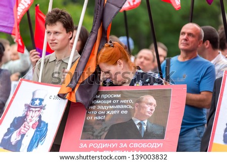 MOSCOW, RUSSIA - 18 MAY 2013: Pro-Putin meeting \'Mass Media - Stop Lying!\' in Moscow, Russia. Placard with Putin portrait reads \'We ask help from him not thinking that he is waiting the same from us\'. Moscow 18 May 2013