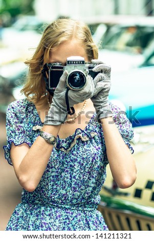 MOSCOW, RUSSIA -  MAY 26: Retro festival \'Days of history\' in Hermitage Garden. Woman with foto camera wearing retro style clothes. Moscow, May 26, 2013