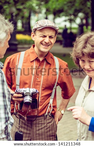 MOSCOW, RUSSIA -  MAY 26: Retro festival \'Days of history\' in Hermitage Garden. Man with film camera wearing in retro style. Moscow, May 26, 2013