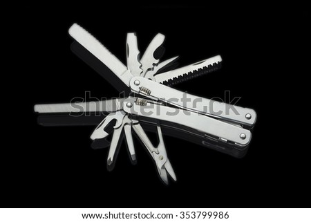 Stainless steel army knife multitool isolated on black