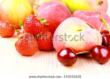 Platt peach, cherries, strawberries, apples and mango, close up