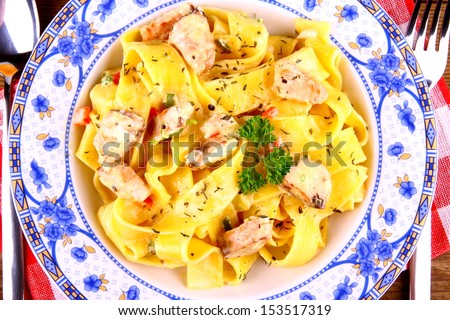 Salmon fish with taglatelle, top view