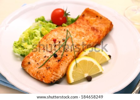 Grilled salmon filet and vegetables, close up, top view