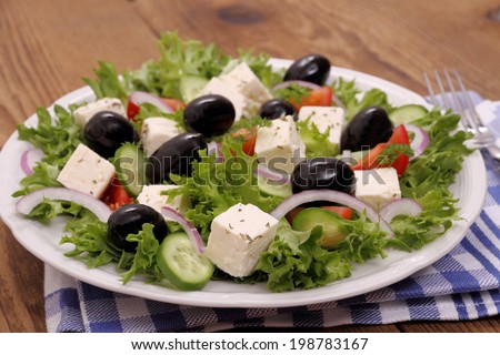 Greek salad with gigantic black olives, sheeps cheese, close up