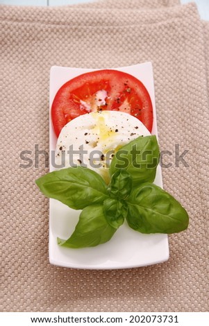 Basil leaf, mozzarella cheese and tomato, vertical