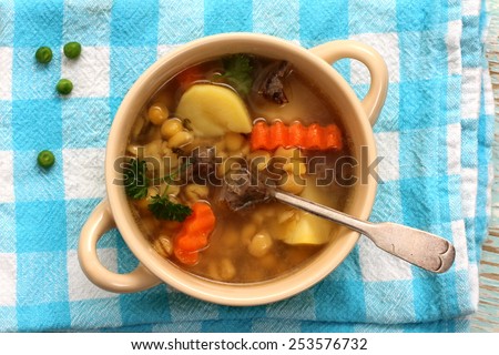 Yellow pea soup, stew meat and potato, top view