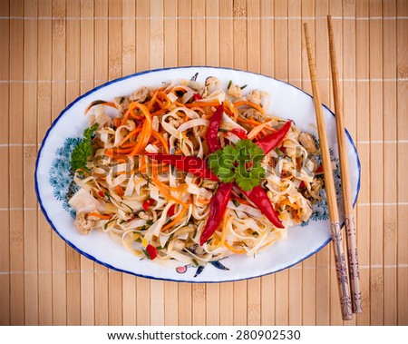 Asian rice noodle with chicken meat and chili star, top view