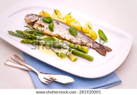 Grilled trout with green asparagus and rosemary potatoes, hollandaise sauce