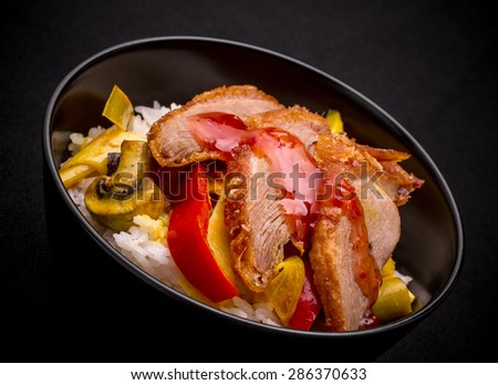 Duck breast with curry vegetables on rice, sweet chili sauce