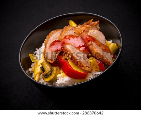 Duck breast with curry vegetables on rice, sweet chili sauce