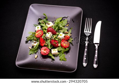 Strawberry tomato salad, feta cheese, olive oil, cutlery, top view