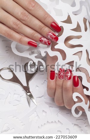 Nails with beautiful winter design and white Christmas decoration paper