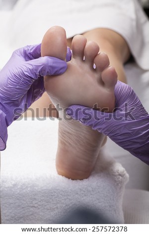 Woman Feet Receiving Foot Massage In Spa