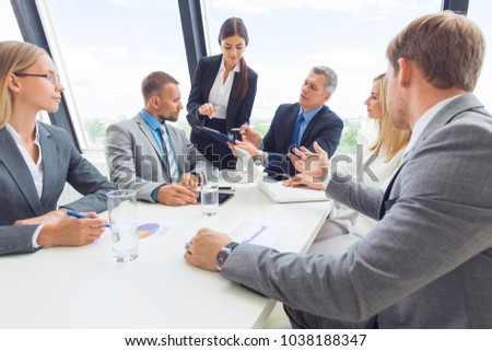 Business team meeting. People in office working with laptop computer and financial reports in desk