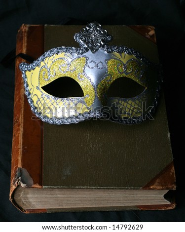 mask and rare old book