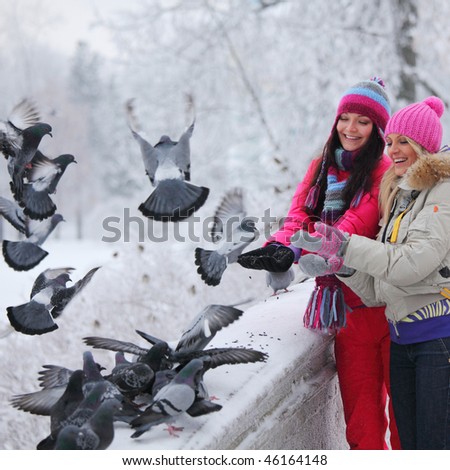  - stock-photo-winter-women-give-food-to-the-pigeon-46164148