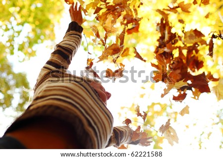 autumn woman drop hands in the air