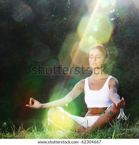 stock photo yoga woman on green grass
