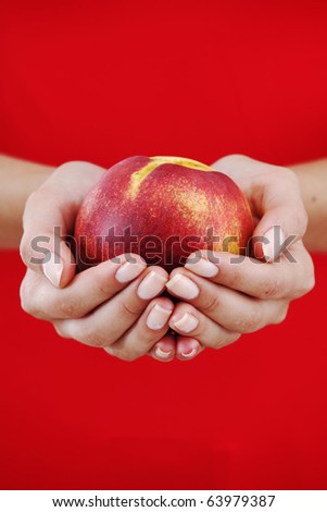 peach in woman hands