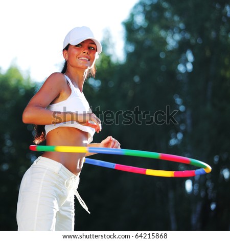woman rotates hula hoop