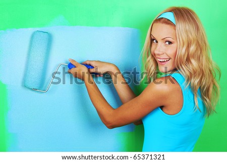 woman paints the wall