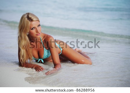 woman lying on the sand the ocean coast