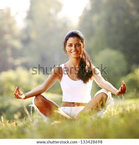 yoga woman on green grass in lotus pose yoga woman on green grass in lotus pose