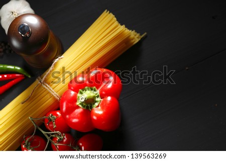 Pasta ingredients on black table, italian cuisine concept