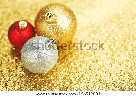 Closeup of Christmas balls on shiny golden background