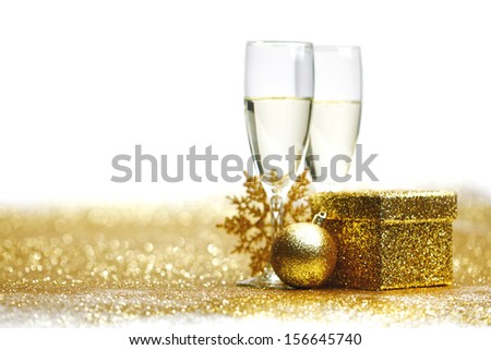 Two glasses of champagne with christmas present and balls