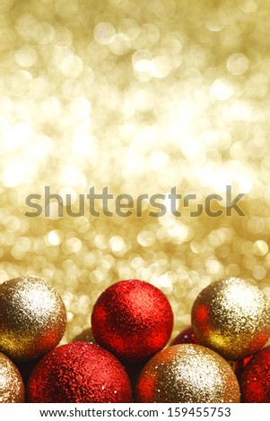 Lots of colorful Christmas Decoration glass baubles on golden background