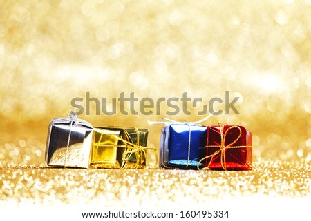 Colorful gift boxes on glitter golden background