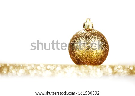 Golden christmas ball on glitter background with white copy space