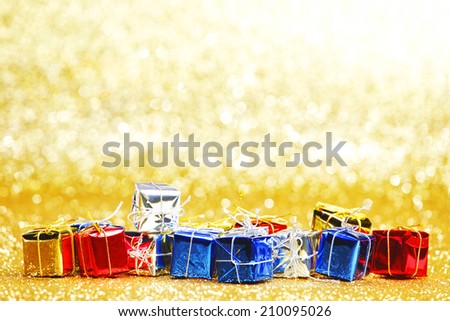Colorful gift boxes on glitter golden background