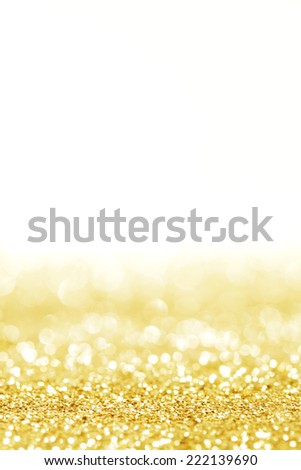Abstract shining glitters gold holiday bokeh background with white copy space
