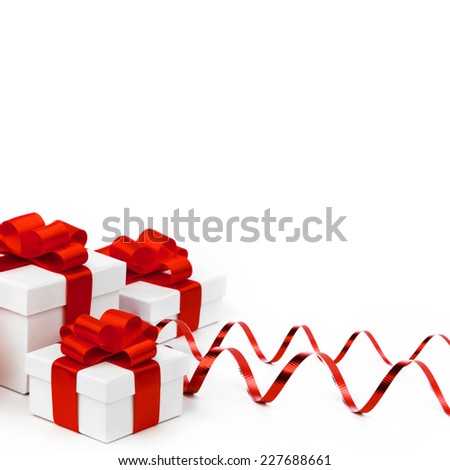 White gift boxes with red ribbons isolated on white background