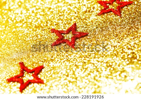 Christmas decorative red stars on shiny glitters background