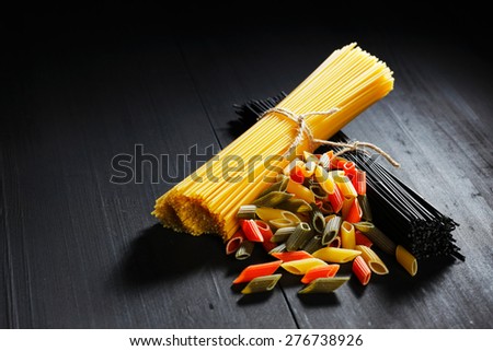 Various Italian pasta on black table