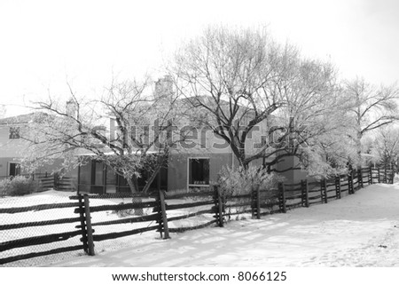 wood fence surrounding a house in the winter