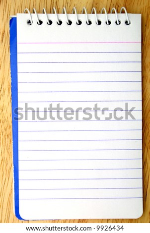 spiral bound notepad on a wood surface
