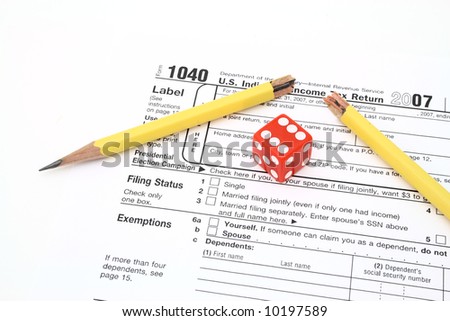red die and broken pencil over 1040 tax form