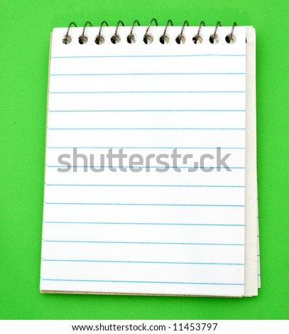 spiral bond notepad over a green surface