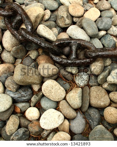 close up on an old and rusty chain over a stone surface