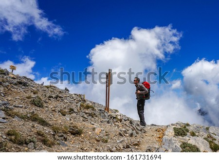 Man reading a sign in the mountains. Greece. Mount Olympus.