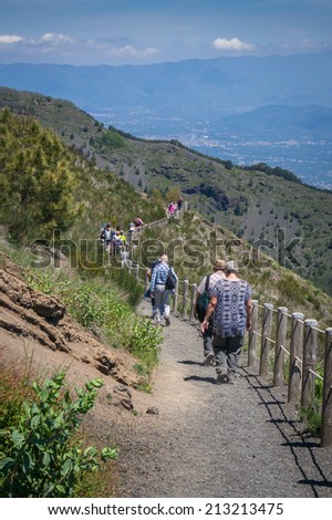 Mount Vesuvius, Italy, May 11, 2014. Tourists descending in line on a narrow path on Mount Vesuvius.