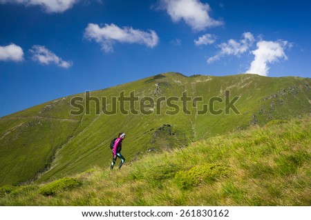 Woman climbing in the mountains in summer