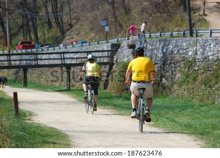 HARPERS FERRY, WV - APRIL 14, 2014: People walk, hike and ride bikes along the Chesapeake and Ohio Canal Towpath which runs along the Potomac River.