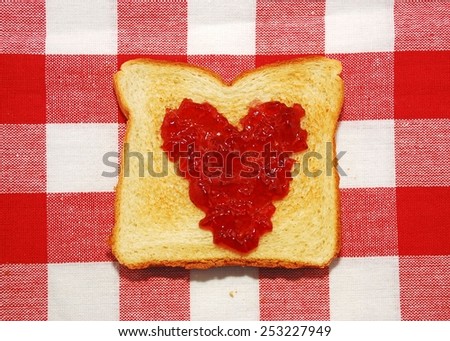 Jelly spread in a heart shape on a piece of toast