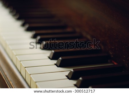 Selective focus of piano keys in natural light and a vintage filter
